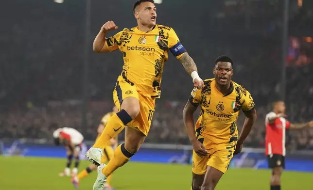 Inter Milan's Lautaro Martinez, left, celebrates after scoring during the Champions League round of 16 first leg soccer match between Feyenoord and Inter Milan in Rotterdam, Netherlands, Wednesday, March 5, 2025. (AP Photo/Peter Dejong)