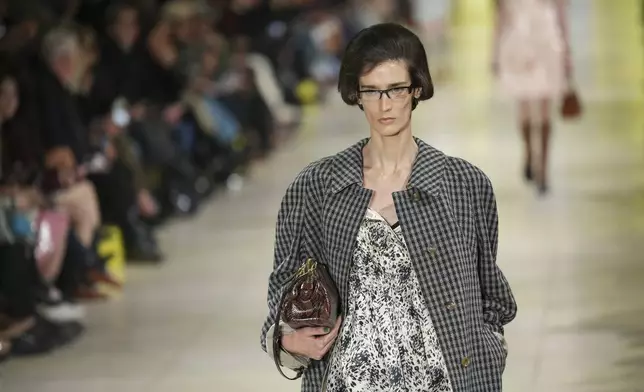 A model wears a creation as part of the Miu Miu Fall/Winter 2025-2026 Womenswear collection presented Tuesday, March 11, 2025. in Paris. (Photo by Scott A Garfitt/Invision/AP)