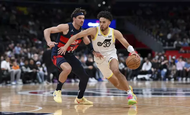 Utah Jazz guard Johnny Juzang (33) handles the ball against Washington Wizards forward Corey Kispert (24) during the first half of an NBA basketball game, Wednesday, Mar. 5, 2025, in Washington. (AP Photo/Terrance Williams)