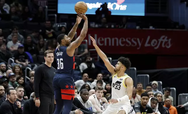 Washington Wizards guard Marcus Smart (36) shoots a three point basket against Utah Jazz guard Johnny Juzang (33) during the first half of an NBA basketball game, Wednesday, Mar. 5, 2025, in Washington. (AP Photo/Terrance Williams)