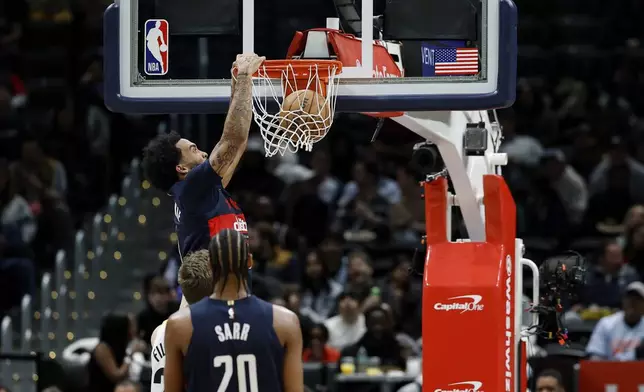Washington Wizards forward Justin Champagnie dunks the ball during the first half of an NBA basketball game against the Utah Jazz, Wednesday, Mar. 5, 2025, in Washington. (AP Photo/Terrance Williams)