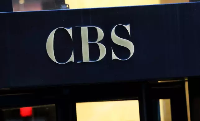 FILE - The CBS logo at the entrance to its headquarters, in New York Dec. 6, 2018. (AP Photo/Mark Lennihan, File)