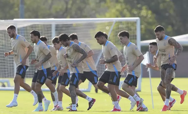 Argentina's players warm up during a training session ahead of a World Cup 2026 soccer qualifier against Uruguay, in Buenos Aires, Argentina, Tuesday, March 18, 2025. (AP Photo/Natacha Pisarenko)