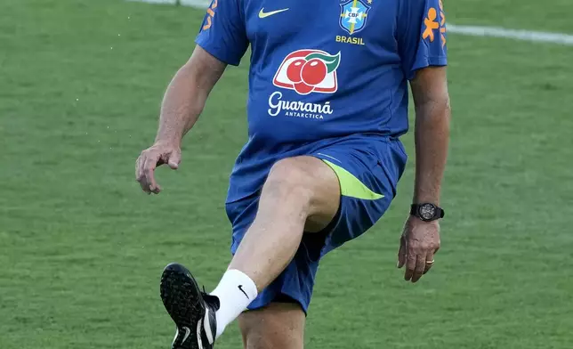 Brazil's coach Dorival Junior controls the ball during a national soccer team training session, in Brasilia, Brazil, Tuesday, March 18, 2025. (AP Photo/Eraldo Peres)