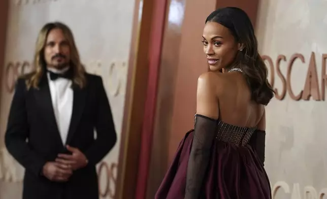 Marco Perego-Saldana, left, and Zoe Saldana arrive at the Oscars on Sunday, March 2, 2025, at the Dolby Theatre in Los Angeles. (Photo by Jordan Strauss/Invision/AP)