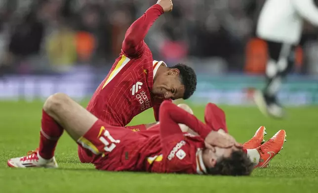 Liverpool's Jarell Quansah and Liverpool's Curtis Jones on the pitch disappointed after losing the EFL Cup final soccer match between Liverpool and Newcastle at Wembley Stadium in London, Sunday, March 16, 2025. (AP Photo/Alastair Grant)