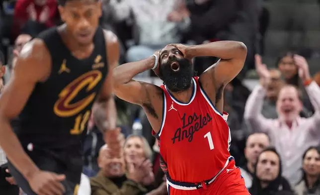 Los Angeles Clippers guard James Harden, right, celebrates after scoring as Cleveland Cavaliers forward De'Andre Hunter runs by during the second half of an NBA basketball game Tuesday, March 18, 2025, in Inglewood, Calif. (AP Photo/Mark J. Terrill)