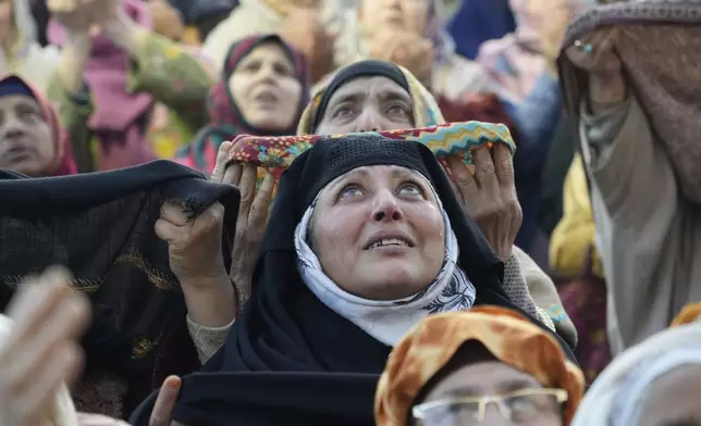 Muslim devotees pray as the head priest displays a holy relic believed to be a hair from the beard of the Prophet Muhammad during special prayers to observe the martyr day of Hazrat Ali, the fourth caliph of Islam, at Hazratbal shrine in Srinagar, Indian controlled Kashmir, Saturday, March 22, 2025 (AP Photo/Mukhtar Khan)