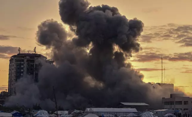 Smoke rises from a building after it was targeted by an Israeli army strike, following evacuation orders for residents, in Gaza City Saturday, March 22, 2025. (AP Photo/Jehad Alshrafi)
