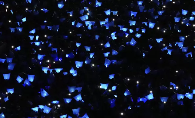 Spectators watch the ceremony before the start of the World Cup qualifying soccer match between Japan and Bahrain at Saitama Stadium in Saitama, Japan, Thursday, March 20, 2025. (AP Photo/Eugene Hoshiko)