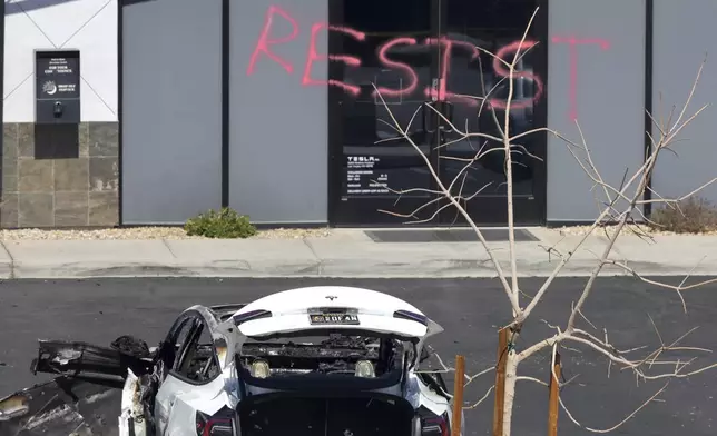 A burned Tesla vehicle is shown at a Tesla collision center Tuesday, March 18, 2025, in Las Vegas. (Steve Marcus/Las Vegas Sun via AP)