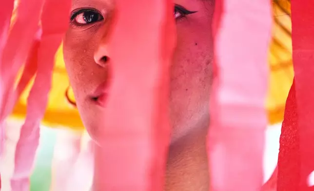 A protester wears a jellyfish costume during a rally outside the Chinese consulate Makati, Philippines, Wednesday, March 19, 2025 as they call on the government to file a case before the International Court of Justice to compel China to pay environmental reparations for it's alleged illegal activities at South China Sea. (AP Photo/Aaron Favila)