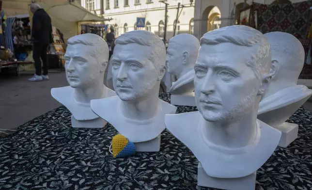 Busts of Ukraine's President Volodymyr Zelenskyy are on sale as souvenirs at a street market in Lviv, Ukraine, Friday, March 21, 2025. (AP Photo/Mykola Tys)