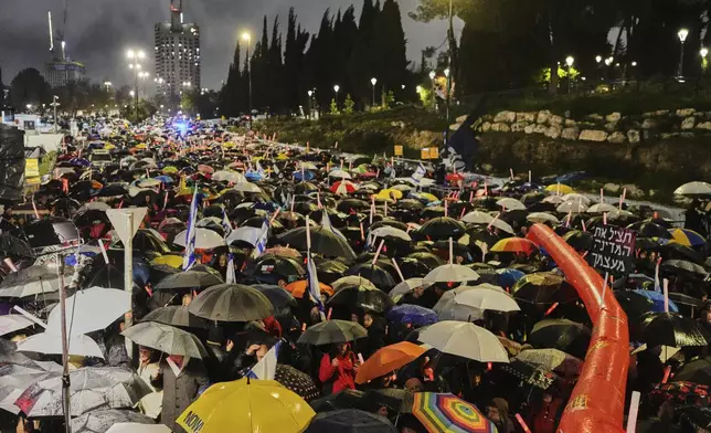 Israelis attend a rally against Prime Minister Benjamin Netanyahu's plan to dismiss the head of the Shin Bet internal security service, and calling for the release of hostages held by Hamas in the Gaza Strip, outside the Knesset, Israel's parliament in Jerusalem on Thursday, March 20, 2025. (AP Photo/Ohad Zwigenberg)