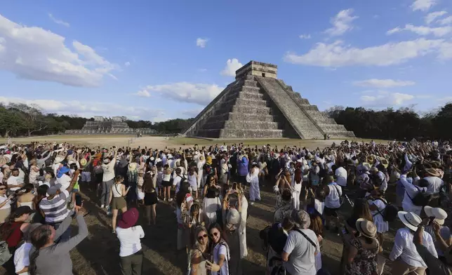 People watch the descent of the Kukulkcan serpent as it draws its shadow on the stairs of the Chichen Itza pyramid in Mexico during a Spring equinox event, Friday, March 21, 2025. (AP Photo/Martin Zetina)