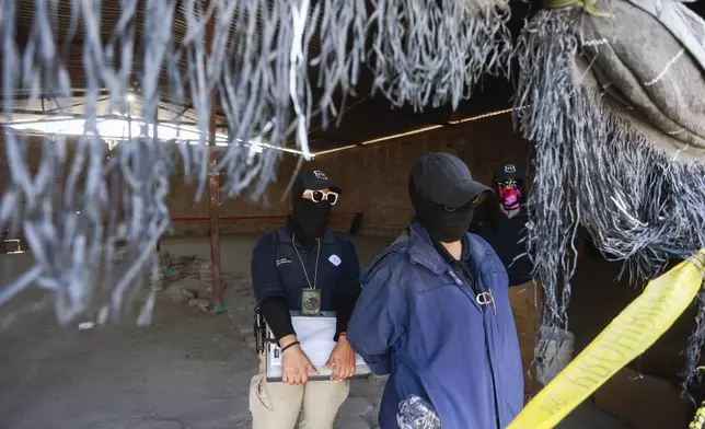State attorney guards stand in front of the interior of Izaguirre Ranch during a tour for the press, days after skeletal remains were discovered on the premises, in Teuchitlan, Jalisco state, Mexico, Thursday, March 20, 2025. (AP Photo/Alfredo Moya)