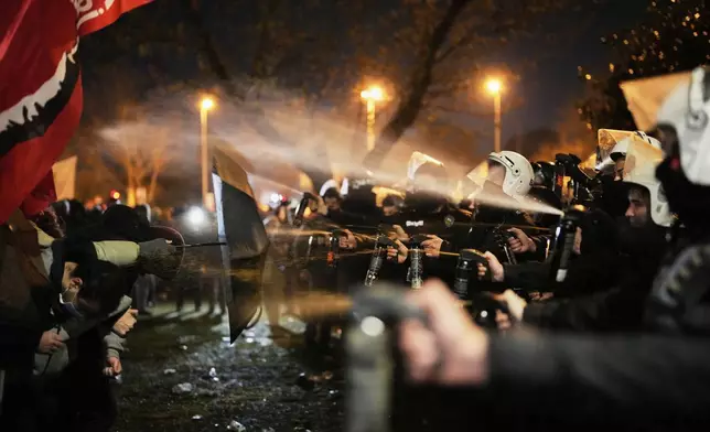 Anti riot police officers use pepper spray during clashes with people in Istanbul, Turkey, Thursday, March 20, 2025, as they protest against the arrest of Istanbul's Mayor Ekrem Imamoglu. (AP Photo/Emrah Gurel)