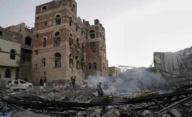Locals inspect the site reportedly struck by U.S. airstrikes overnight in Sanaa, Yemen, Thursday, March 20, 2025. (AP Photo)