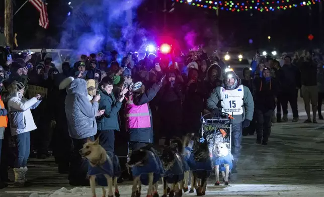 Jessie Holmes mushes down Front Street on his way to winning the Iditarod Trail Sled Dog Race early Friday morning, March 14, 2025 in Nome. (Loren Holme/Anchorage Daily News via AP)
