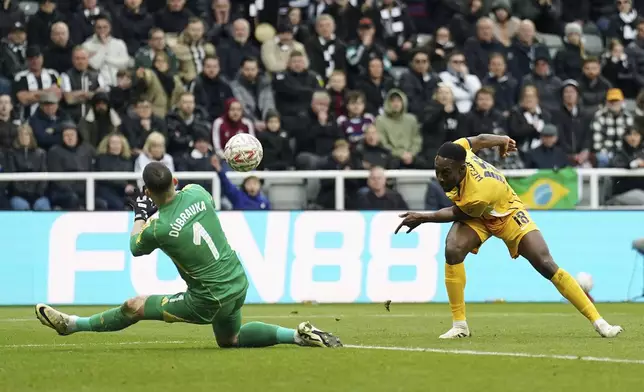 Brighton and Hove Albion's Danny Welbeck, right, scores their side's second goal during the FA Cup fifth round match between Newcastle United and Brighton and Hove Albion at St James' Park, Newcastle, England, Sunday, March 2, 2025. (Owen Humphreys/PA via AP)
