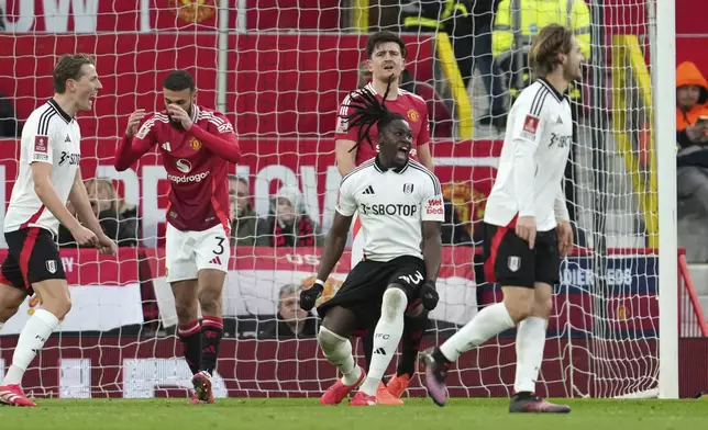 Fulham's Calvin Bassey, centre, celebrates after scoring his side's opening goal during the English FA Cup soccer match between Manchester United and Fulham at the Old Trafford stadium in Manchester, England, Sunday, March 2, 2025. (AP Photo/Jon Super)