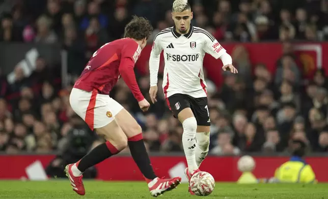 Fulham's Andreas Pereira, right, challenges for the ball with Manchester United's Matthijs de Ligt during the English FA Cup soccer match between Manchester United and Fulham at the Old Trafford stadium in Manchester, England, Sunday, March 2, 2025. (AP Photo/Jon Super)