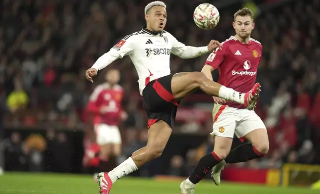 Fulham's Rodrigo Muniz, left, challenges for the ball with Manchester United's Matthijs de Ligt during the English FA Cup soccer match between Manchester United and Fulham at the Old Trafford stadium in Manchester, England, Sunday, March 2, 2025. (AP Photo/Jon Super)