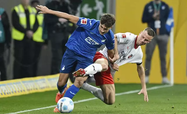 Hoffenheim's Tom Bischof, left, and Heidenheim's Adrian Beck in action during the Bundesliga soccer match between TSG 1899 Hoffenheim and 1. FC Heidenheim at PreZero Arena, Sinsheim, Germany, Sunday March 9, 2025. (Uwe Anspach/dpavia AP)