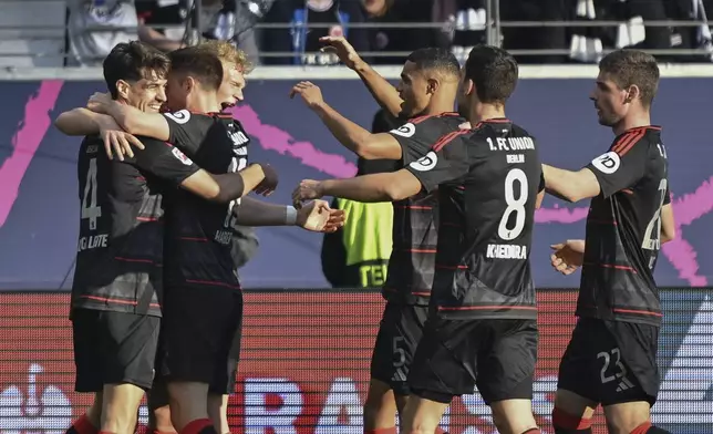 Union Berlin's Leopold Querfeld, 3rd left, celebrates scoring with teammates during the German Bundesliga soccer match between Eintracht Frankfurt and 1. FC Union Berlin at Deutsche Bank Park, in Frankfurt, Germany, Sunday, March 9, 2025. (Arne Dedert/dpa via AP)