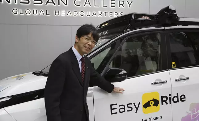 Takeshi Kimura, a Nissan engineer overseeing the Japanese automaker’s self-driving technology, shows the car packed with the technology to reporters at Nissan headquarters in Yokohama, near Tokyo, on March 6, 2025. (AP Photo/Yuri Kageyama)