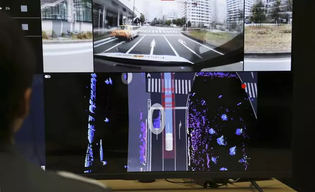Nissan officials remotely monitor on screens the path and surroundings of the self-driving vehicle being tested on regular roads, so they can step in if problems happen, at Nissan headquarters in Yokohama, near Tokyo, on March 6, 2025. (AP Photo/Yuri Kageyama)