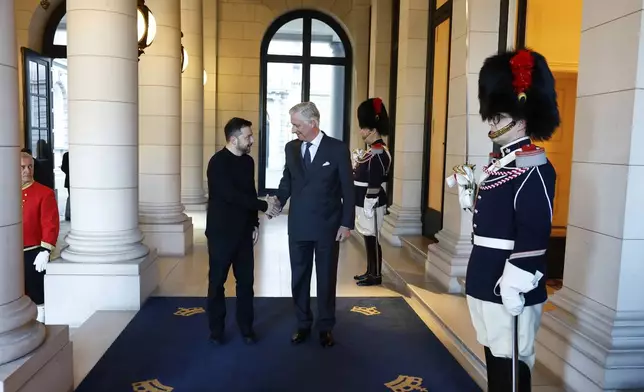 Belgium's King Philippe, right, greets Ukraine's President Volodymyr Zelenskyy prior to a meeting at the Royal Palace in Brussels, Thursday, March 6, 2025. (AP Photo/Stephanie Lecocq, Pool Photo via AP)
