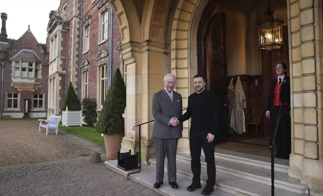 Britain's King Charles III and Ukrainian President Volodymyr Zelenskyy, right, shake hands during their meeting at the Sandringham Estate in Norfolk, England, Sunday, March 2, 2025. (Joe Giddens/Pool via AP)