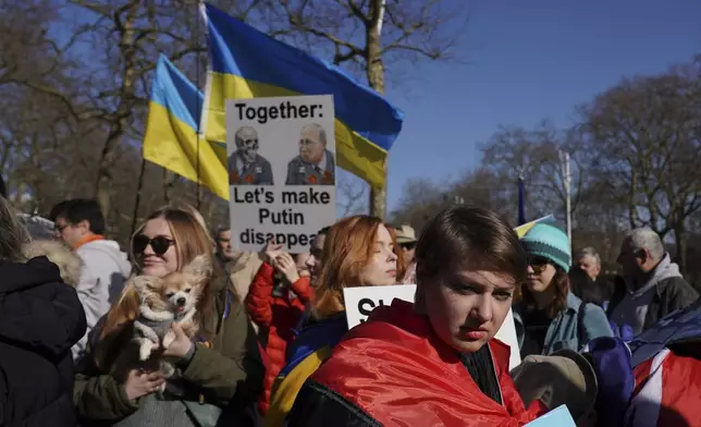 Ukrainian supporters waving flags pictures and banners demonstrate as they walk down the Mall as Britain's Prime Minister Keir Starmer chairs a Ukraine Summit at Lancaster House in London, Sunday, March 2, 2025. (AP Photo/Alberto Pezzali)
