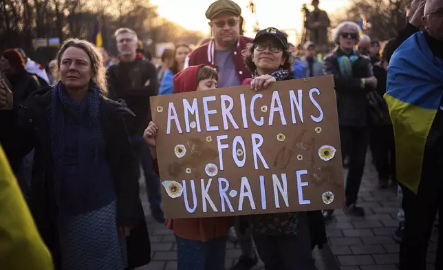People take part in a demonstration against Russia's war on Ukraine in Berlin, Germany, Sunday, March 9, 2025. (AP Photo/Markus Schreiber)