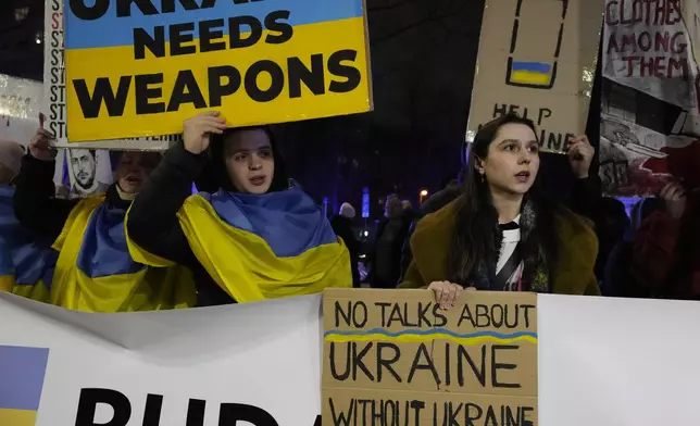 People hold a demonstration in support of Ukraine outside the U.S. Embassy in Warsaw, Poland, on Monday March 3, 2025. (AP Photo/Czarek Sokolowski)
