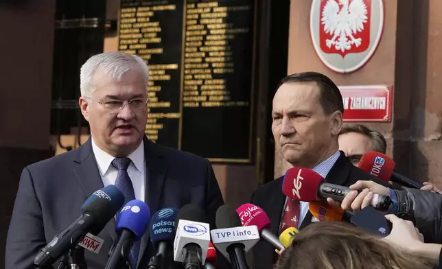 Ukrainian Foreign Minister Andrii Sybiha, left, and Polish Foreign Minister Radek Sikorski, right, address the media during press conference in Warsaw, Poland, Wednesday, March 12, 2025. (AP Photo/Czarek Sokolowski)