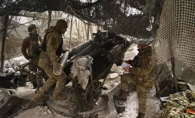 Ukrainian servicemen fire a M777 howitzer towards Russian positions at the frontline near Donetsk, Ukraine, Sunday, March, 2, 2025. (AP Photo/Roman Chop)