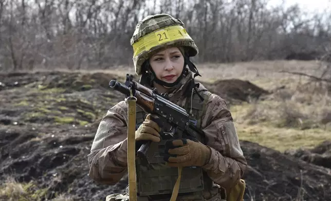 In this photo provided by Ukraine's 65th Mechanised Brigade press service, Ukrainian servicewoman, Daria, 36, practices at a military training ground in the Zaporizhzhia region, Ukraine, Monday, March 10, 2025. (Andriy Andriyenko/Ukraine's 65th Mechanised Brigade via AP)