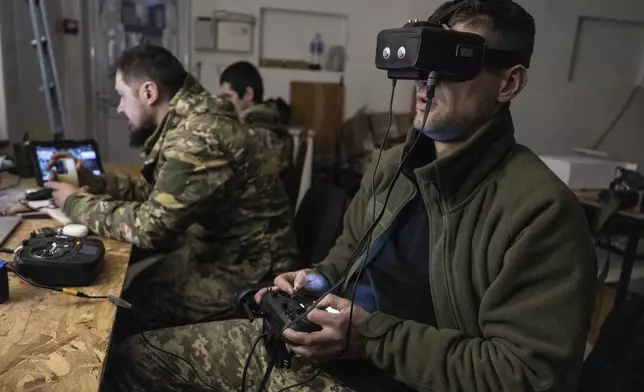 In this photo provided by Ukraine's 93rd Kholodnyi Yar Separate Mechanized Brigade press service, Ukrainian soldiers control FPV drones from a shelter in Pokrovsk, the site of heavy battles with Russian troops in the Donetsk region, Ukraine, Sunday, March 9, 2025. (Iryna Rybakova/Ukraine's 93rd Mechanized Brigade via AP)