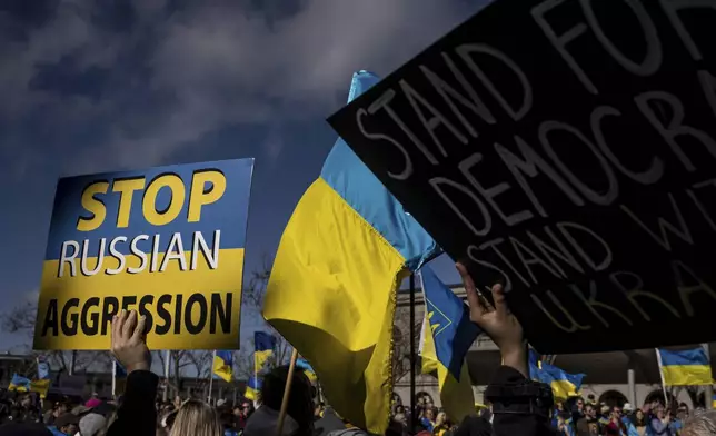 Rally participants hold signs for passing traffic as Bay Area United for Ukraine held an emergency rally to show support for the country at Harry Bridges Plaza in San Francisco, Sunday, March 2, 2025. (Carlos Avila Gonzalez/San Francisco Chronicle via AP)