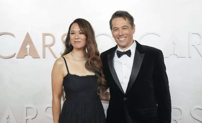 Samantha Quan, left, and Sean Baker arrive at the Oscars on Sunday, March 2, 2025, at the Dolby Theatre in Los Angeles. (AP Photo/Jae C. Hong)