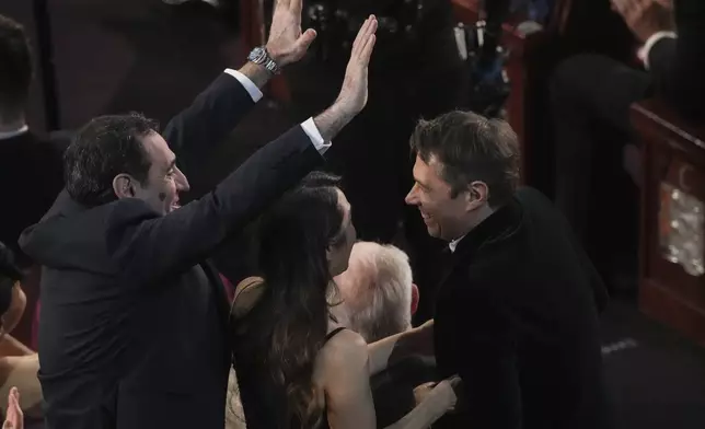 Karren Karagulian, from left, Samanthan Quan, and congratulate Sean Baker for winning the award for best film editing for "Anora" during the Oscars on Sunday, March 2, 2025, at the Dolby Theatre in Los Angeles. (AP Photo/Chris Pizzello)
