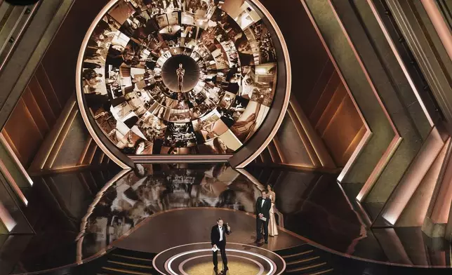 Sean Baker accepts the award for best director for "Anora" during the Oscars on Sunday, March 2, 2025, at the Dolby Theatre in Los Angeles. Quentin Tarantino look on from right.(AP Photo/Chris Pizzello)