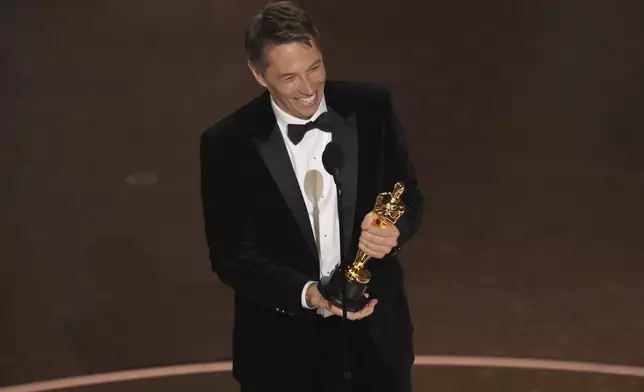 Sean Baker accepts the award for best director for "Anora during the Oscars on Sunday, March 2, 2025, at the Dolby Theatre in Los Angeles. (AP Photo/Chris Pizzello)