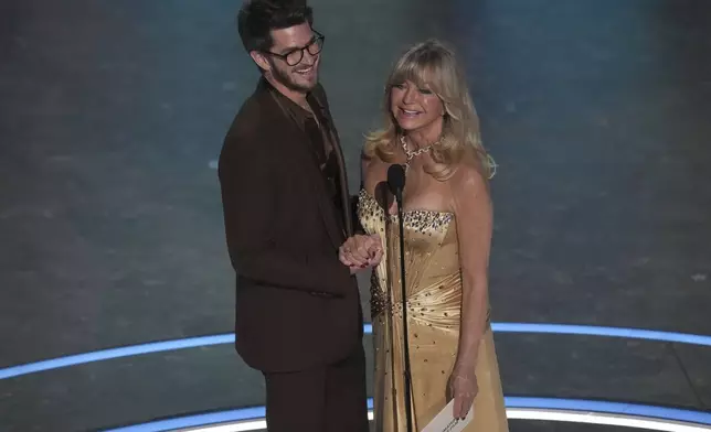 Andrew Garfield, left, and Goldie Hawn present the award for best animated feature film during the Oscars on Sunday, March 2, 2025, at the Dolby Theatre in Los Angeles. (AP Photo/Chris Pizzello)
