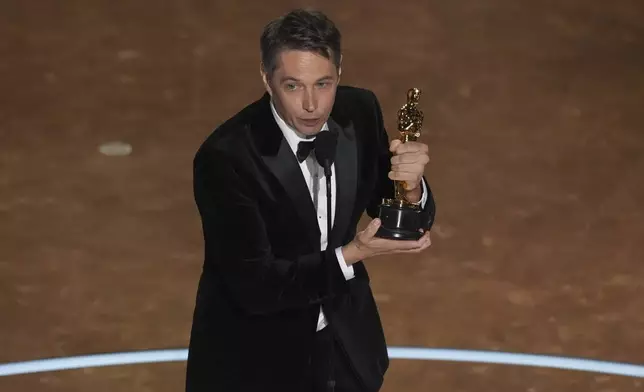 Sean Baker accepts the award for best original screenplay for "Anora" during the Oscars on Sunday, March 2, 2025, at the Dolby Theatre in Los Angeles. (AP Photo/Chris Pizzello)