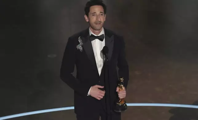 Adrien Brody accepts the award for best performance by an actor in a leading role for "The Brutalist" during the Oscars on Sunday, March 2, 2025, at the Dolby Theatre in Los Angeles. (AP Photo/Chris Pizzello)