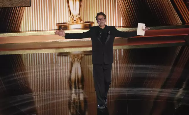 Robert Downey Jr. presents the award for best performance by an actor in a supporting role during the Oscars on Sunday, March 2, 2025, at the Dolby Theatre in Los Angeles. (AP Photo/Chris Pizzello)