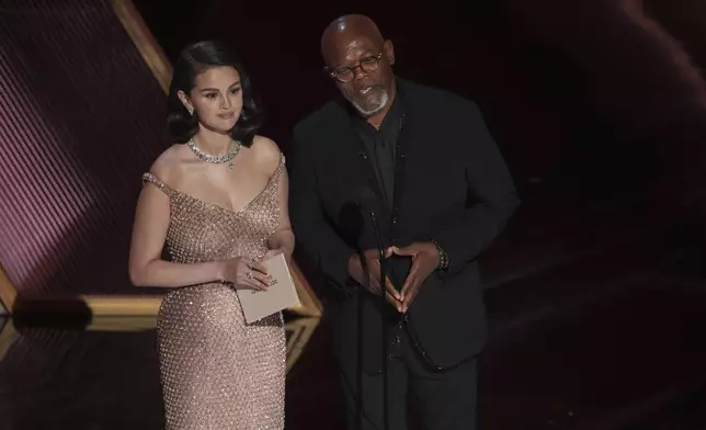 Selena Gomez, left, and Samuel L. Jackson present the award for best documentary short film during the Oscars on Sunday, March 2, 2025, at the Dolby Theatre in Los Angeles. (AP Photo/Chris Pizzello)
